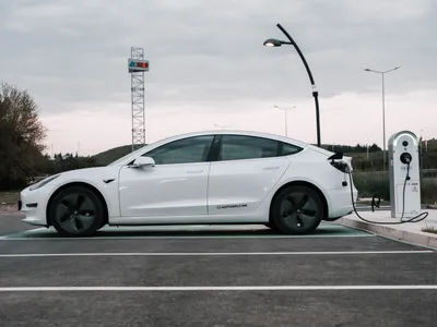 Tesla Model 3 Long Range plugged in at charging station
